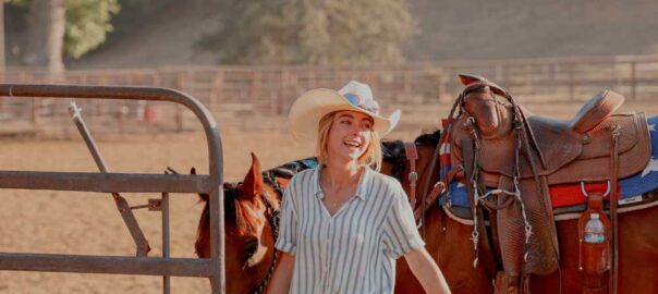 saddle up girl getting ready to ride horse