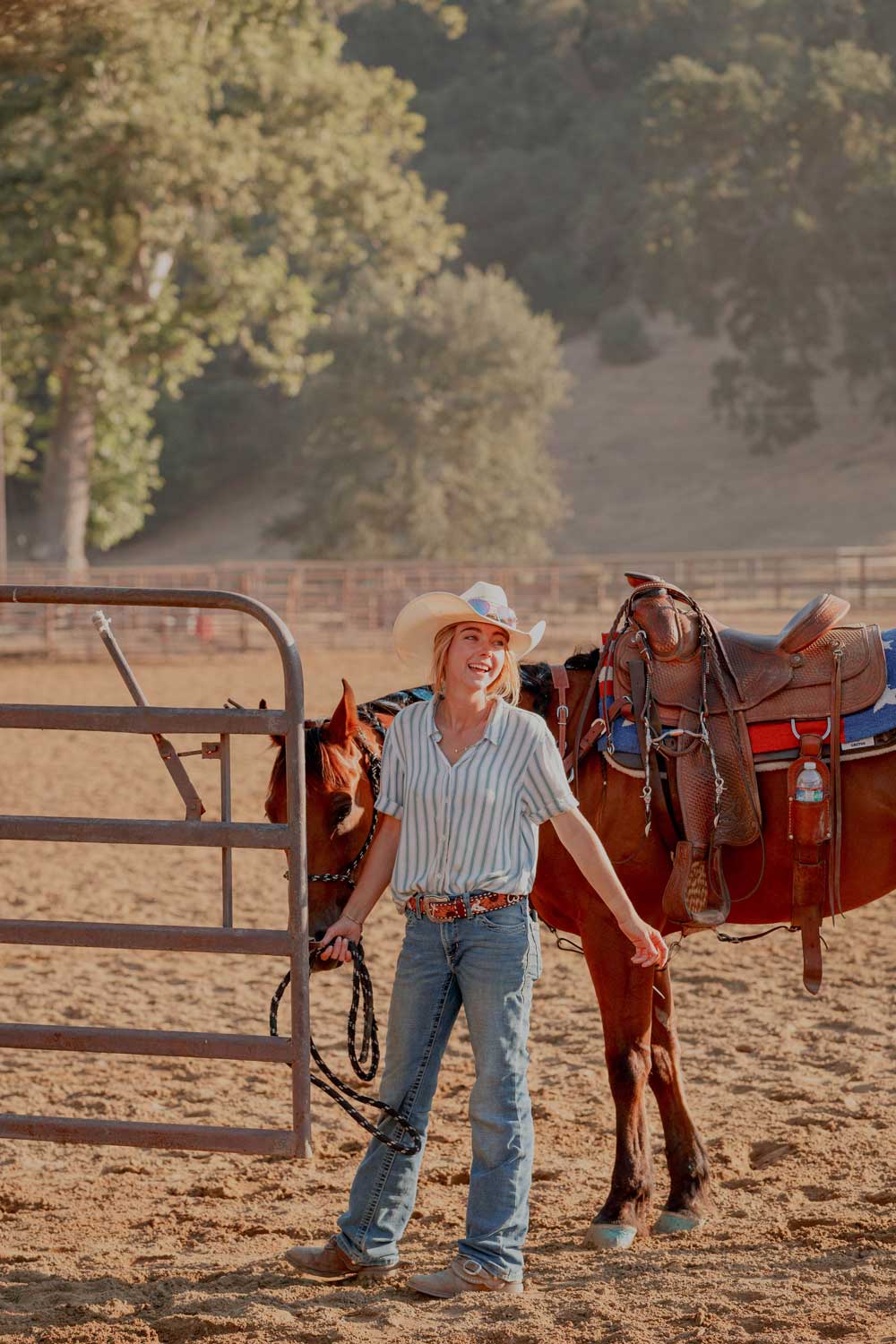 saddle up girl getting ready to ride horse