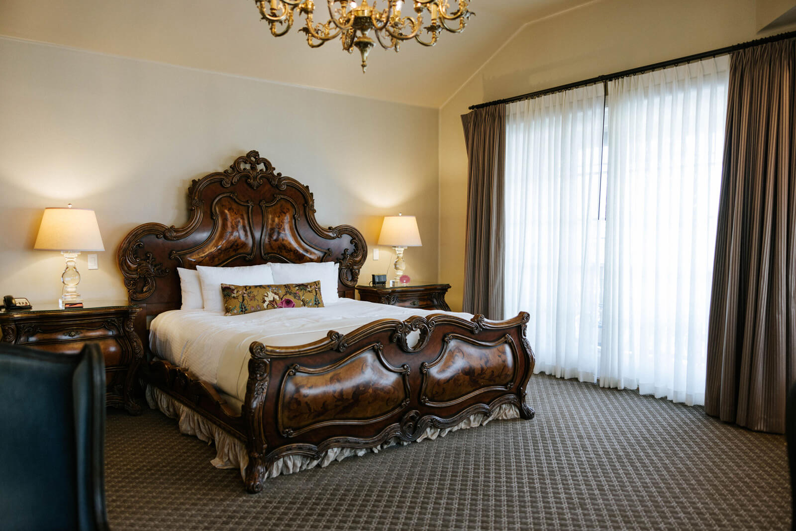 Getting Here Large wood bed in hotel room