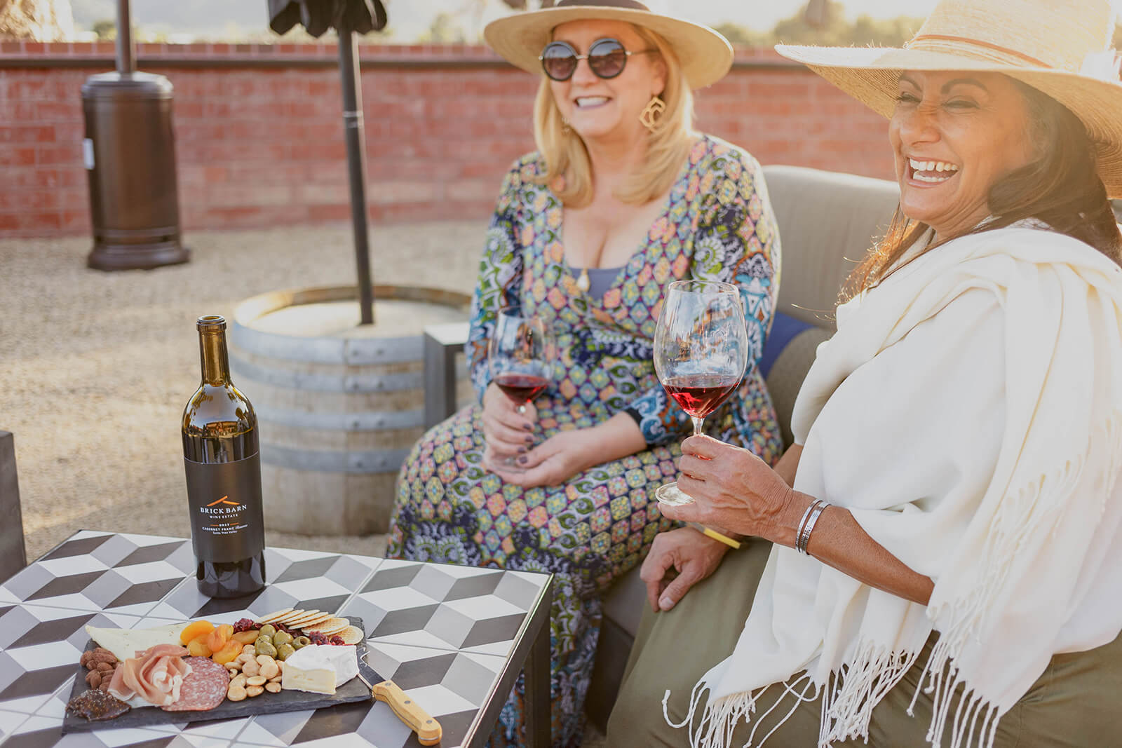 Meetings Women enjoying wine and snacks at an outdoor table in Buellton, California