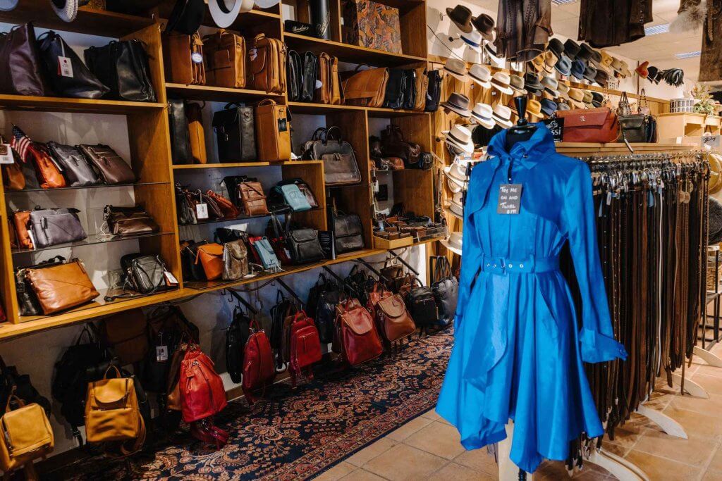 An assortment of clothes with a prominent blue dress.
